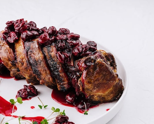 duroc pork with cherry compote drizzled on top 