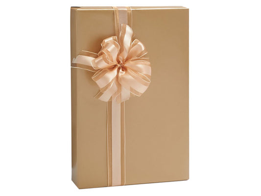 Gold wrapped gift with stripped bow before white background.