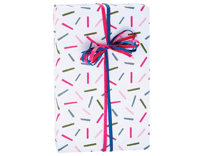 Sprinkle themed gift wrapped with blue and pink string on white background.